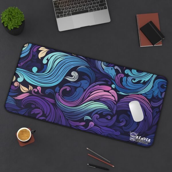 Flat-lay image of a floral desk mat with pink, blue, and coral tones, featuring an intricate swirling pattern of flowers and petals.