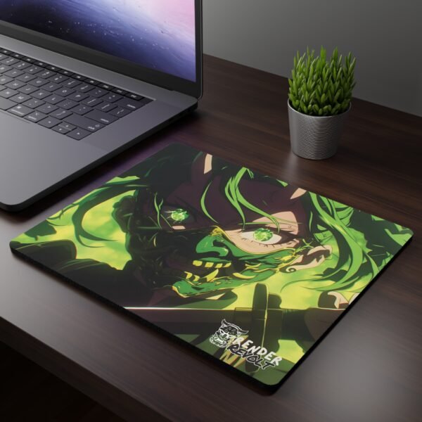 Meiko Demon Mouse Pad - A mouse pad featuring an intense anime-style character with glowing green eyes, a demonic mask, and green hair, placed on a dark wooden desk beside a laptop and a small potted plant.