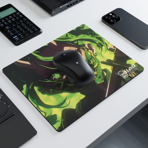 A mouse pad with an anime-style warrior wearing a green demonic mask and glowing eyes, set on a white desk alongside a black wireless mouse, a calculator, a smartphone, and other office accessories.